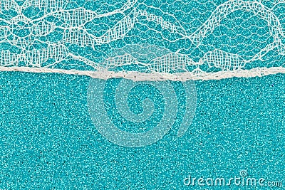 Delicate lace textured material on teal paper background Stock Photo