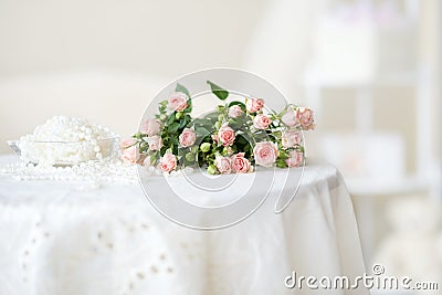 Delicate pink roses and pearl beads on the table Stock Photo