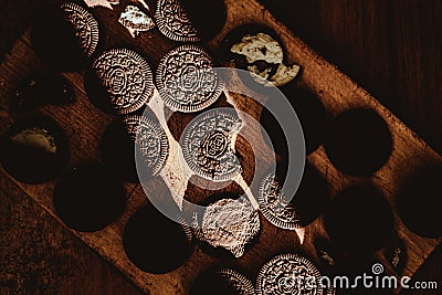 Delicate sweet chocolate oreo cookies on a wooden table on a beautiful sunny day Editorial Stock Photo