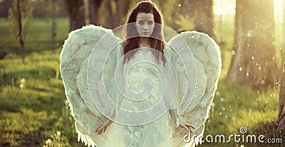 Delicate woman dressed as an angel Stock Photo