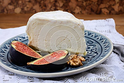 Delice de Bourgogne French cow's milk cheese from Burgundy region of France served with fresh figs and walnuts Stock Photo