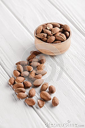 delicious almonds in wooden bowl on white Stock Photo