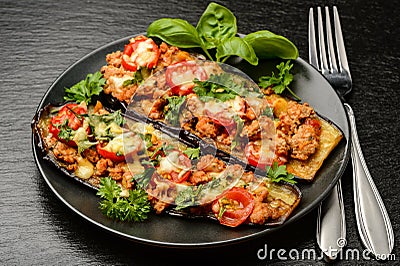 Delicious appetizer -grilled eggplants baked with minced meat, tomatoes and cheese. Stock Photo