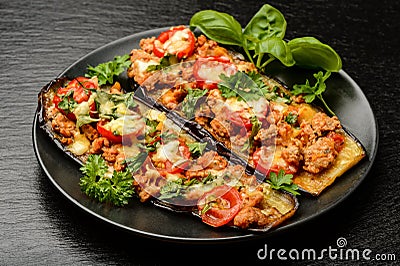 Delicious appetizer -grilled eggplants baked with minced meat, tomatoes and cheese. Stock Photo