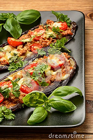 Delicious appetizer -grilled eggplants baked with minced meat, tomatoes and cheese. Stock Photo