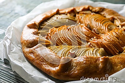 Delicious apple galette with walnuts on wooden table, closeup Stock Photo