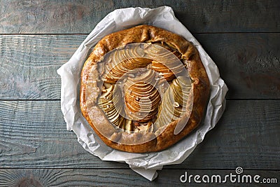 Delicious apple galette with walnuts on wooden table, top view Stock Photo