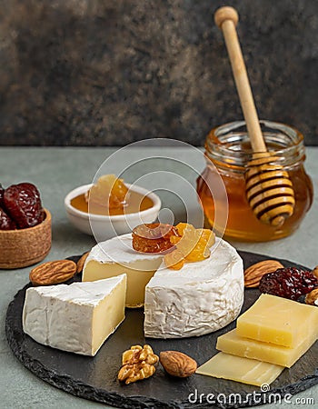 Delicious artisan cheese dish with honey and dried fruits Stock Photo