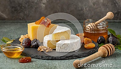 Delicious artisan cheese dish with honey and dried fruits Stock Photo