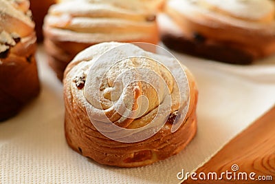 Delicious baked cruffins with raisins, dried apricots and powdered sugar. Stock Photo