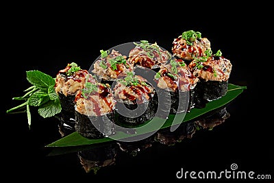 Baked maki sushi roll with eel, cream cheese, cucumber and unagi sauce Stock Photo
