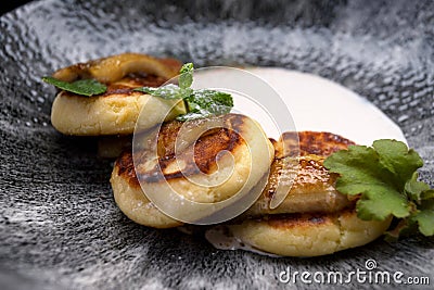 Delicious banana pancakes with sour cream and mint leaves Stock Photo