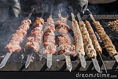 Delicious bbq grilling meat on open grill, outdoor kitchen. Food festival in city. tasty food roasting on skewers, food Stock Photo