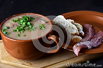 delicious bean broth with bacon, bread and pepper, typical Brazilian food Stock Photo