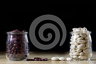 Delicious bean in a glass jar on a wooden kitchen table. Stock Photo