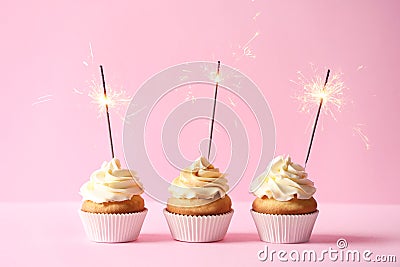 Delicious birthday cupcakes with burning sparklers Stock Photo