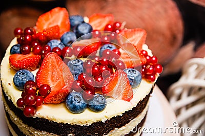 Delicious biscuit cake with a topping of lots of berries close up Stock Photo