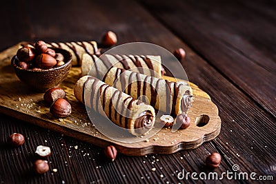 Biscuit tubes filled with hazelnut cream and chocolate topping Stock Photo