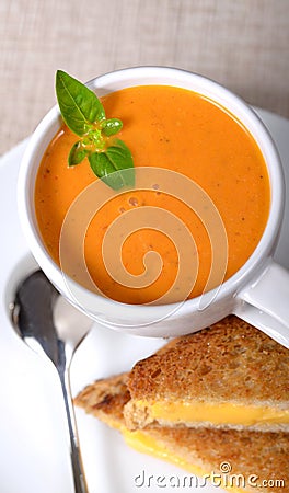 Delicious bowl of tomato soup with grilled cheese sandwich Stock Photo