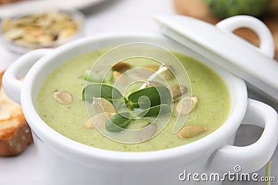 Delicious broccoli cream soup with pumpkin seeds in bowl, closeup Stock Photo