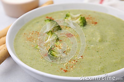 Delicious broccoli cream soup served on light table, closeup Stock Photo