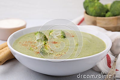 Delicious broccoli cream soup served on light table, closeup Stock Photo