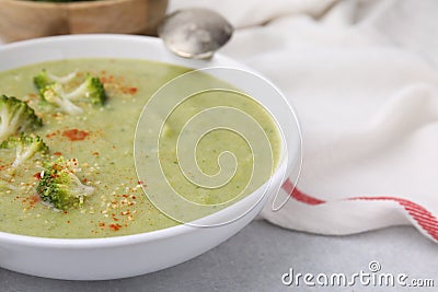 Delicious broccoli cream soup served on light table, closeup. Space for text Stock Photo