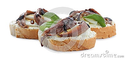 Delicious bruschettas with anchovies, eggs, basil and sauce on white background Stock Photo