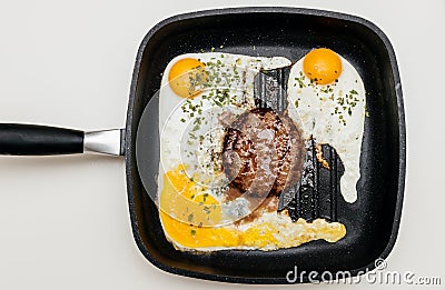 Delicious burger in pan with yolk eggs seen from above Stock Photo