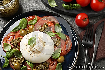 Delicious burrata salad served on grey table, flat lay Stock Photo