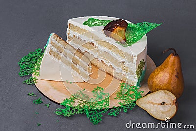 A delicious cake decorated with caramelized pears on a gray background. Stock Photo