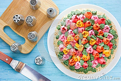 Delicious cake decorated with colorful cream flowers tulips Stock Photo