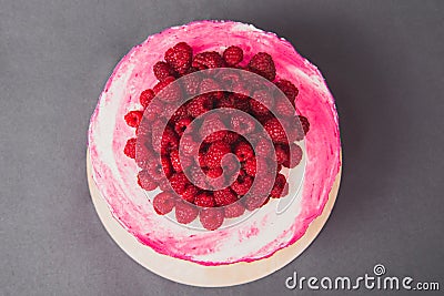 A delicious cake decorated with raspberries on a gray background. Stock Photo