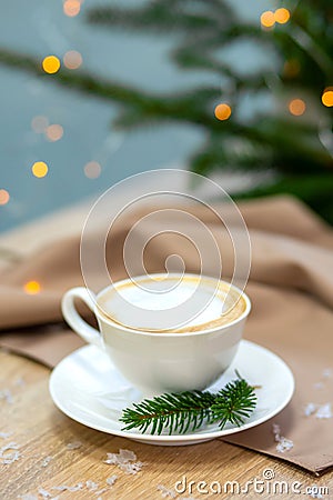 Delicious cappucino coffee cup . fireflies and spruce branches Stock Photo