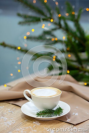 Delicious cappucino coffee cup . fireflies and spruce branches Stock Photo