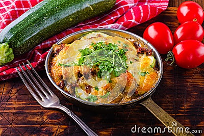 Delicious casserole of zucchini and minced meat. Casserole with herbs. A nice dinner. A hot dinner. Stock Photo