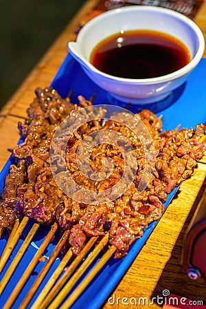 A delicious charcoal-grilled raw beef, grilled small skewers Stock Photo