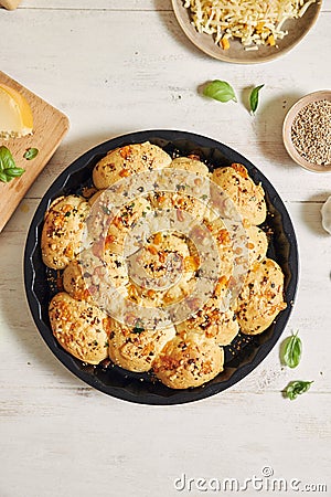 Delicious cheese bubble pizza bread with ingredients and cheese on a white table Stock Photo