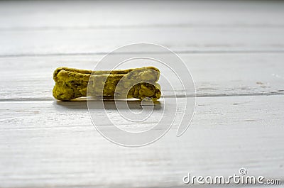 Delicious chewing bone for dogs with different tastes on white wooden background Stock Photo