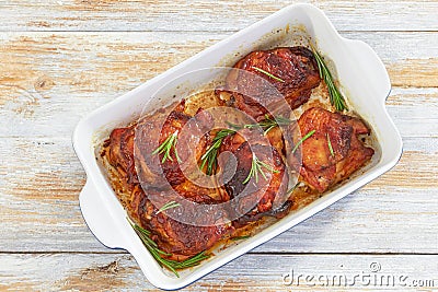 Delicious chicken thigh roasted in rectangular baking dish Stock Photo