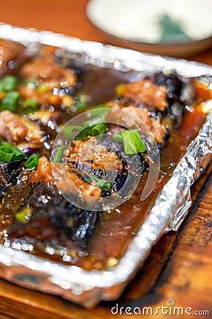 A delicious Chinese dish, teppanyaki eggplant stuffed with meat Stock Photo
