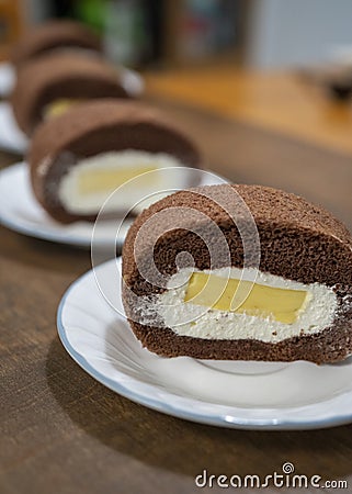 Delicious chocolate cake roll with cream and mango pudding Stock Photo