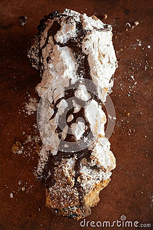 chocolate cigar pastry pastries baked goods bakery powdered sugar chocolate cinnamon cocoa hands holding Stock Photo
