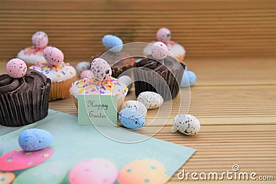 Delicious chocolate mini cakes with egg decorations and happy Easter words or text Stock Photo
