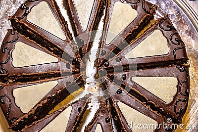 Delicious chocolate Sacher cake, cutting to the pieces. Stock Photo