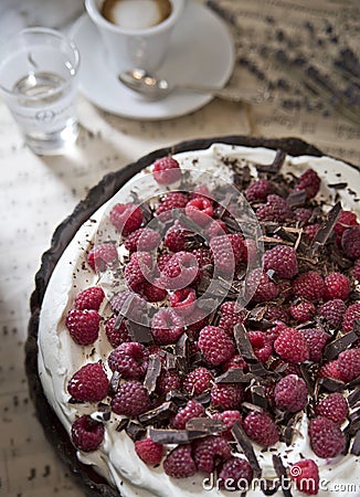 Delicious chocolate tart with cream and raspberry on the background of vintage notes, with a cup of flavored espresso Stock Photo