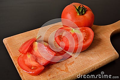 Fresh and Vibrant Chopped Tomato Slices on a Wooden Kitchen Board Stock Photo