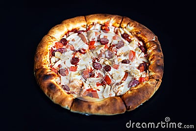 Delicious classic italian Pizza Pepperoni with sausages and cheese mozzarella. black dark background Stock Photo