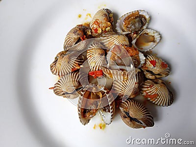 Delicious cockles or oyster in hot sauce is an Indonesian seafood dish of kerang dara served in hot and spicy chilli sauce Stock Photo