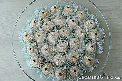 Delicious coconut candies with clove on the top, called Beijinho or Branquinho. Stock Photo